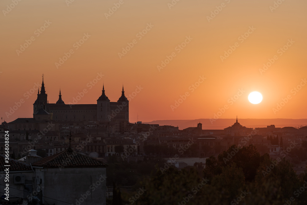 Old city with historic buildings and stone castle on hill against sky during sunset Old city with historic buildings and stone castle on hill against sky during sunset