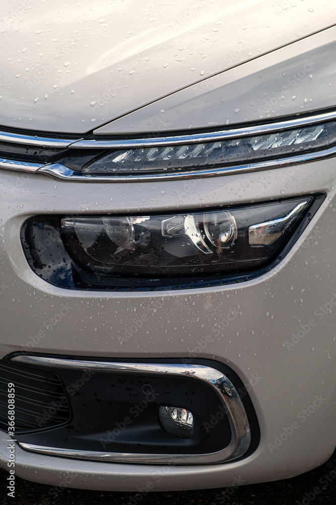 Modern headlights with a complex design and construction. Close-up of the front of the car