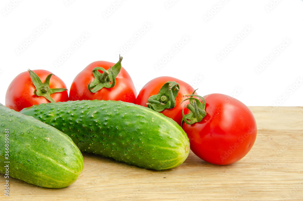 Fresh tomatoes and cucumber. Red and green vegetables. Cherry tomatoes vegetables white background Fresh tomatoes and cucumber. Red and green vegetables. Cherry tomatoes vegetables white background
