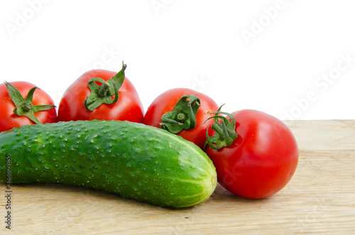 Fresh tomatoes and cucumber. Red and green vegetables. Cherry tomatoes vegetables white background