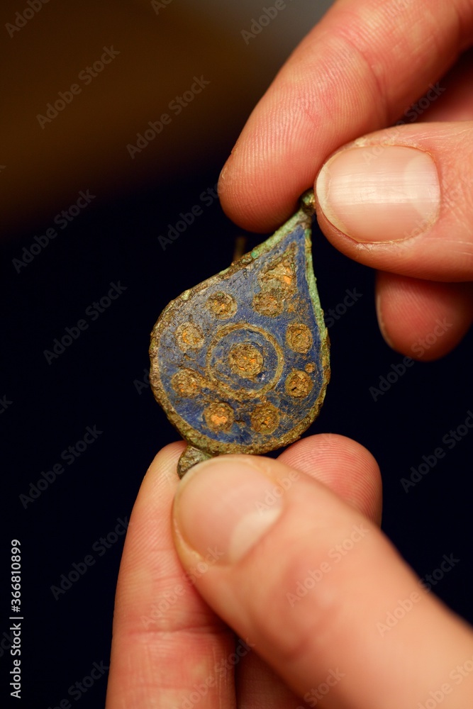 Artefacts being examined by an Archaeology student Artefacts being examined by an Archaeology student