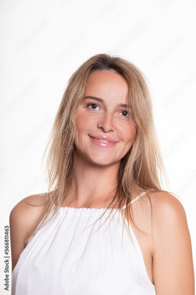 Very beautiful young blonde European girl caucasian with long hair and healthy, smooth, well groomed white skin. Vertical portrait for advertising face care cosmetics. Very beautiful young blonde European girl caucasian with long hair and healthy, smooth, well groomed white skin. Vertical portrait for advertising face care cosmetics.