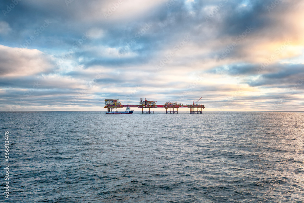 Offshore oil platform at sunset time