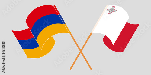 Crossed and waving flags of Malta and Armenia