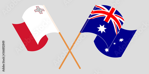 Crossed and waving flags of Malta and Australia