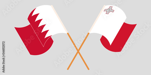 Crossed and waving flags of Malta and Bahrain