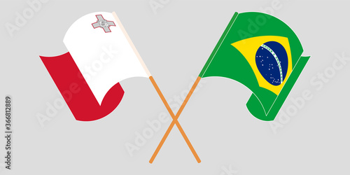 Crossed and waving flags of Malta and Brazil