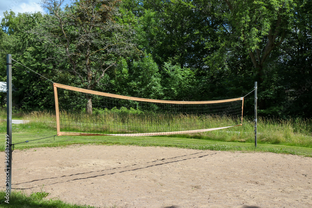 An empty volleyball court outside in the sunshine An empty volleyball court outside in the sunshine