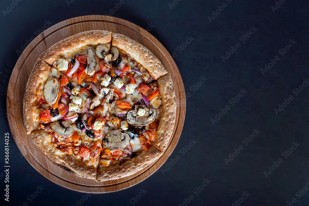 Pizza with vegetables on a dark background