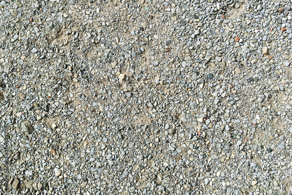 Decorative crushed gray pieces fine gravel stones for construction industry. Stones background. Top view. Abstract texture. Background for design. Close-up. Decorative crushed gray pieces fine gravel stones for construction industry. Stones background. Top view. Abstract texture. Background for design. Close-up.