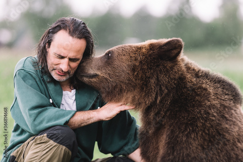 An adult man and a bear hug.
