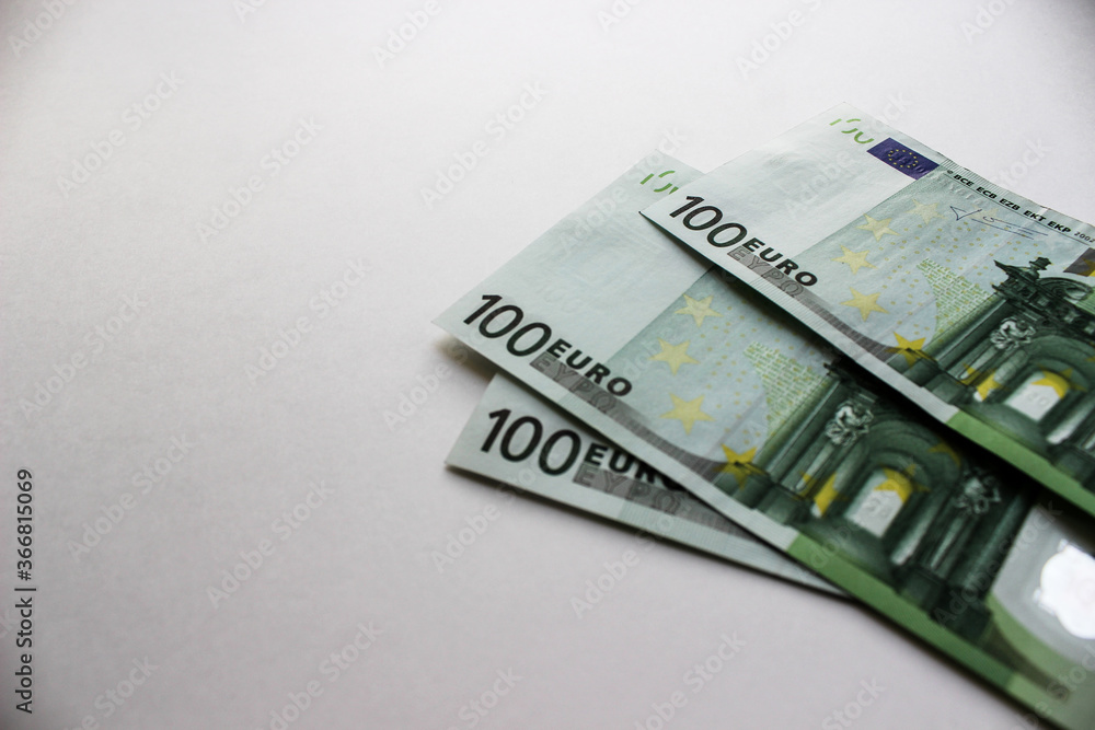 Close-up of 100 Euro banknotes isolated on white background. Currency, financial Close-up of 100 Euro banknotes isolated on white background. Currency, financial