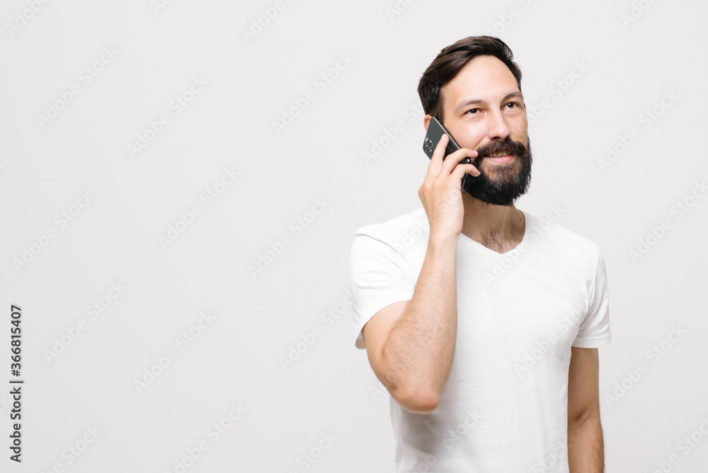 cheerful young man is using a mobile phone. cheerful young man is using a mobile phone.