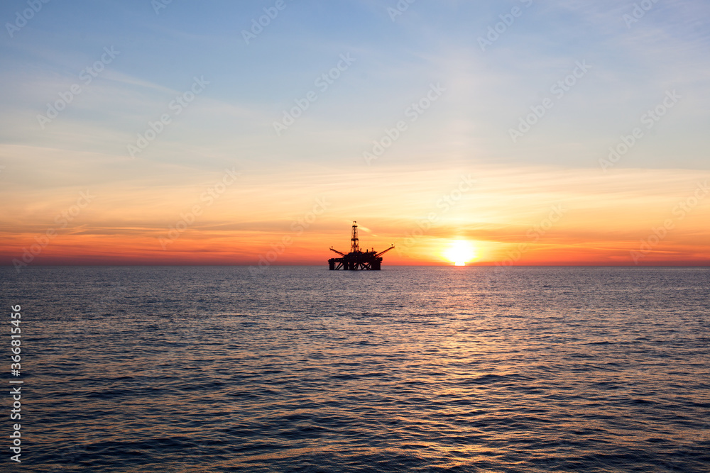 Offshore oil rig at sunset time Offshore oil rig at sunset time