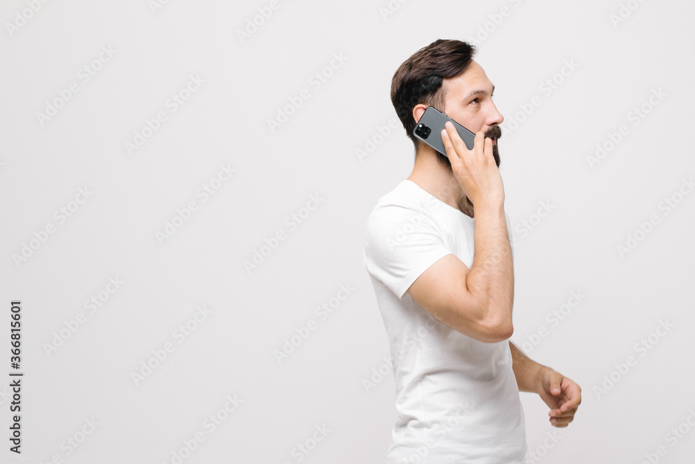 cheerful young man is using a mobile phone. cheerful young man is using a mobile phone.