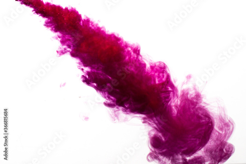A cloud of red paint is released into the clear water. Isolate on a white background.