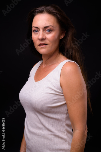 Portrait of mature beautiful woman against black background