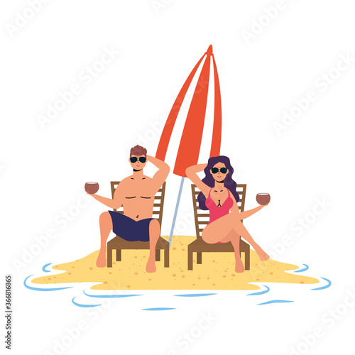young couple relaxing on the beach seated in chairs and umbrella