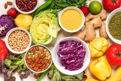 Vegetarian food. Food background. Various vegetables, legumes, seeds and nuts on a light background top view, flat lay.