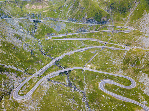 Beautiful long and curvy tarmac road viewed from a drone. 