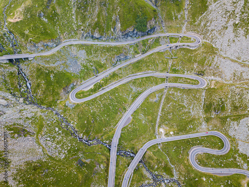 Beautiful long and curvy tarmac road viewed from a drone. 