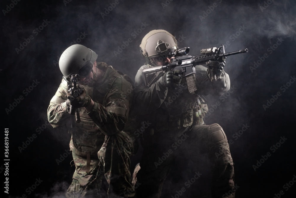 two soldiers in military uniform with weapons in a special operation at  night, special forces attack against a dark background, elite troops Stock  Photo | Adobe Stock