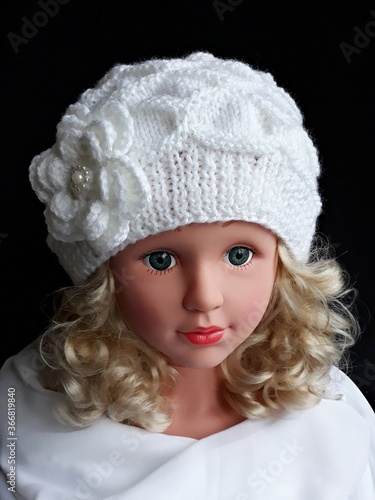 Unique hand knitted ladies hat, white color, decorated with a crocheted flower.