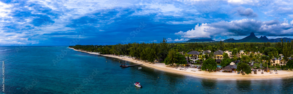 Aerial view, the beach of Flic en Flac with luxury hotels and palm trees, behind the mountain Tourelle du Tamarin and Trois Mamelles, Mauritius, Africa