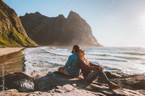 Couple in love man and woman enjoying Kvalvika beach view travel lifestyle together romantic holidays family vacation outdoor in Norway summer trip