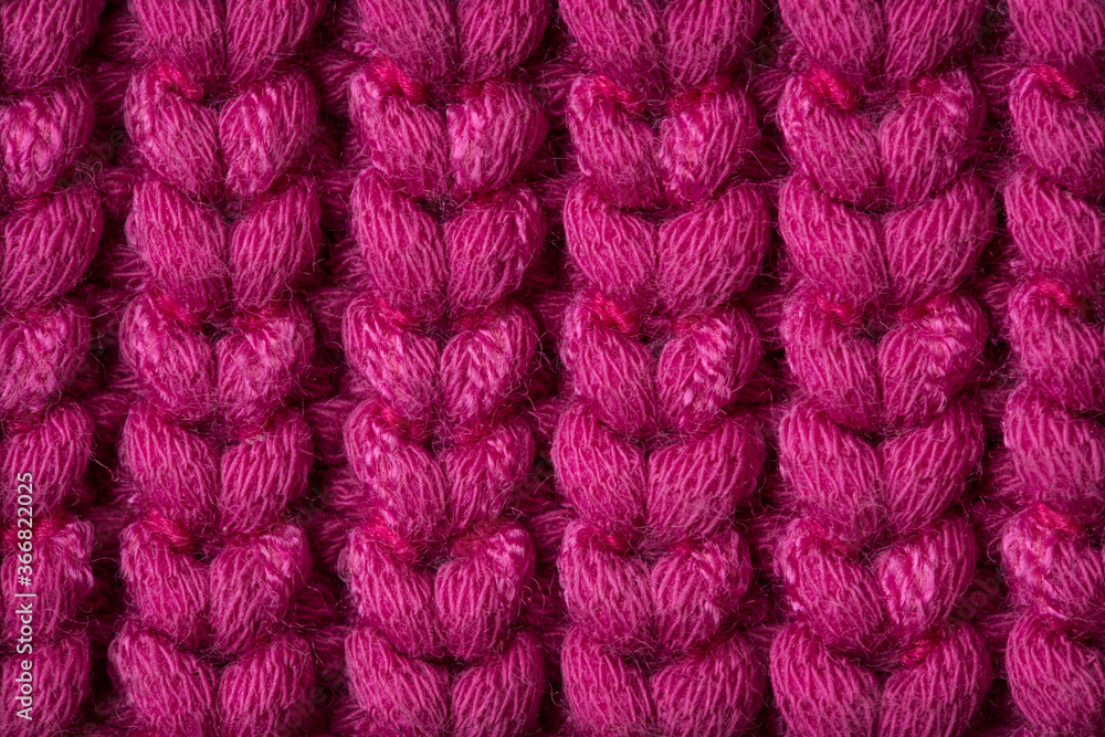 The texture of the knit woolen fabric is purple. Background, top view.