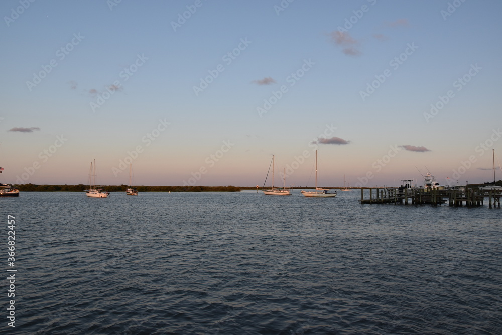 Sailboats on the bay at sunset