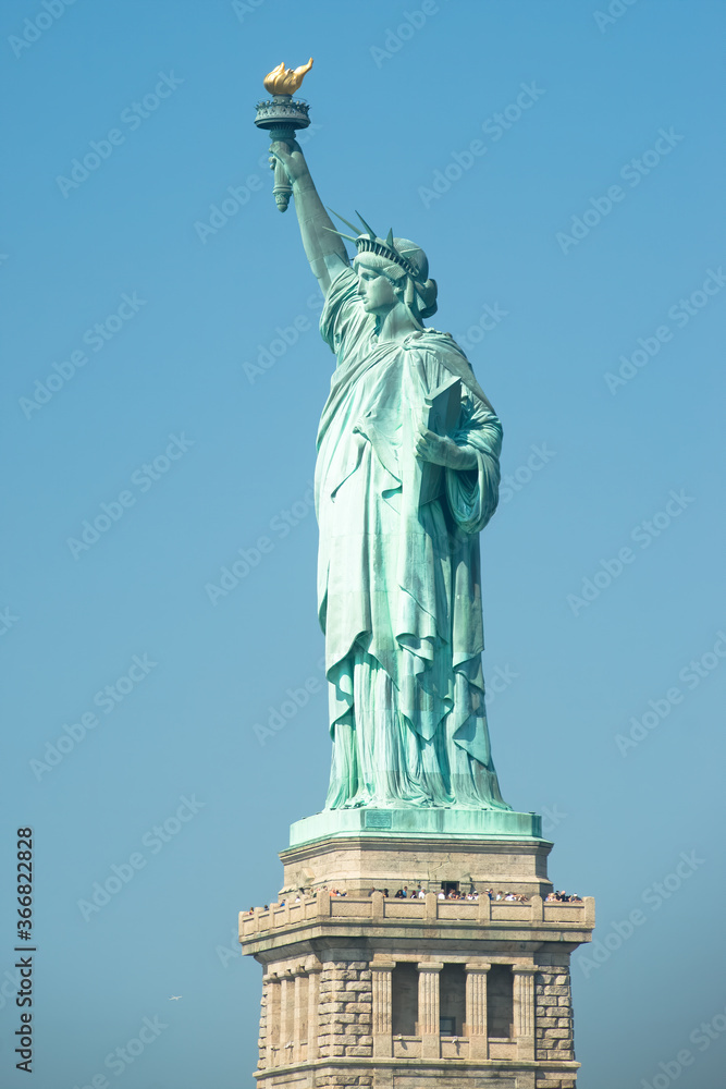 Statue of liberty with blue sky during sunny day in summer.