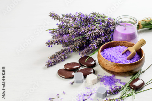 Lavender flowers, candle, salt and soap on the white background.