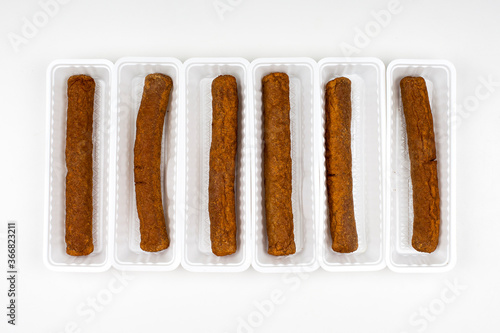 Six fried fricandel in a white plastic container photo