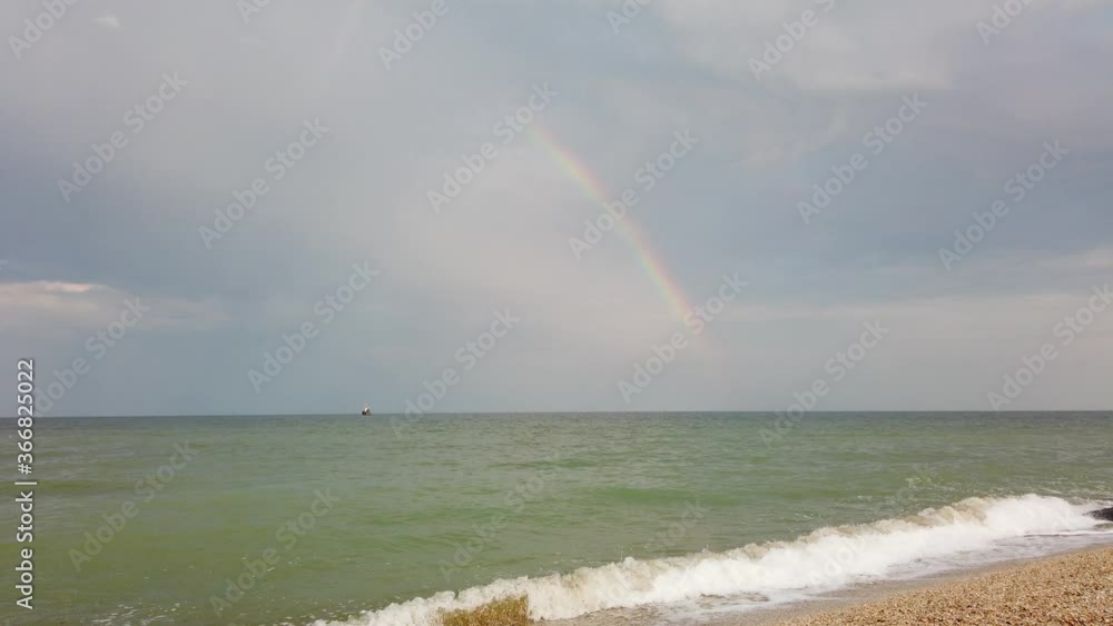 Rainbow in the sky. Sea and clouds.
Rainbow in the sky. Sea and clouds.