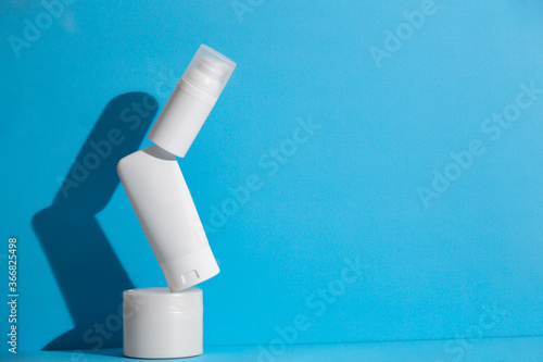 Set of blank white skincare cosmetic products on background with free space for advertising text.