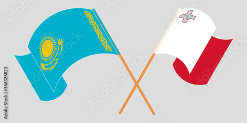 Crossed and waving flags of Malta and Kazakhstan