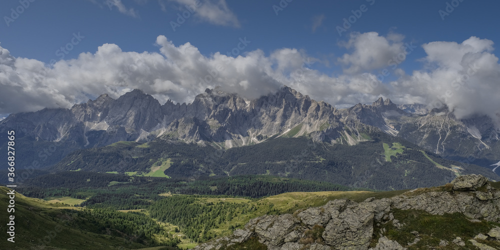 Fototapeta premium View of Sesto Dolomites massif and Tre Cime di Lavaredo iconic summits in Italy as seen from Carnic Alps ridge and passes along the Carnic Peace Trail, Cranic Alps Highroute trek, Austria.