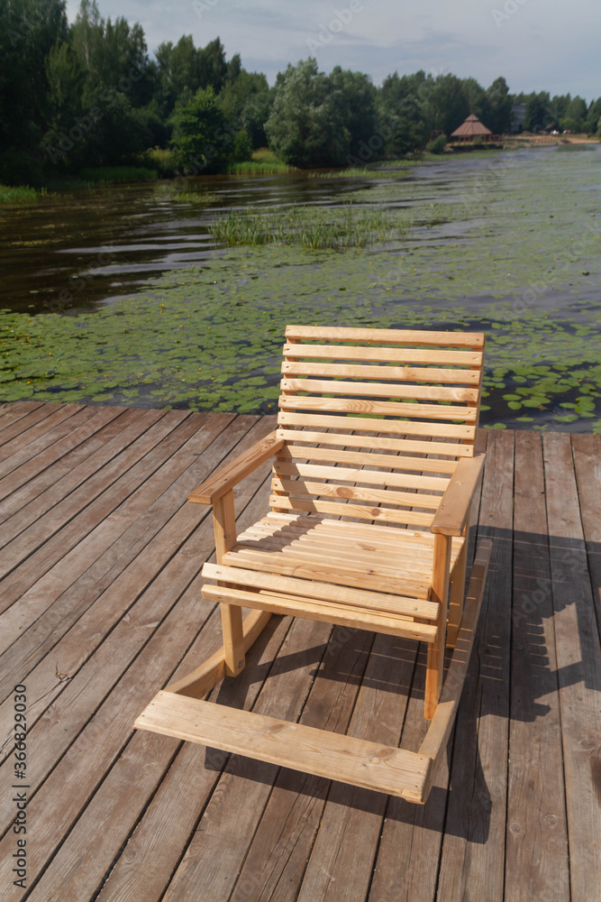 Wooden rocking chair on the river Bank, lake for people to relax. Wooden rocking chair on the river Bank, lake for people to relax.