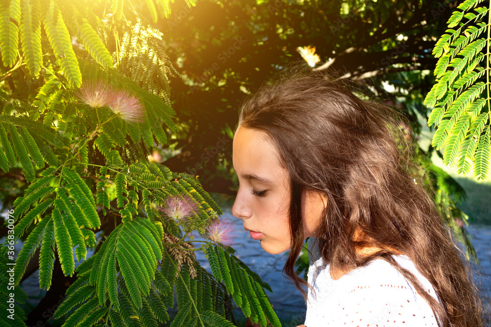 Portrait of a beautiful tanned caucasian cute girl in the tropical greenery. Travel, vacation, warm countries. Portrait of a beautiful tanned caucasian cute girl in the tropical greenery. Travel, vacation, warm countries.