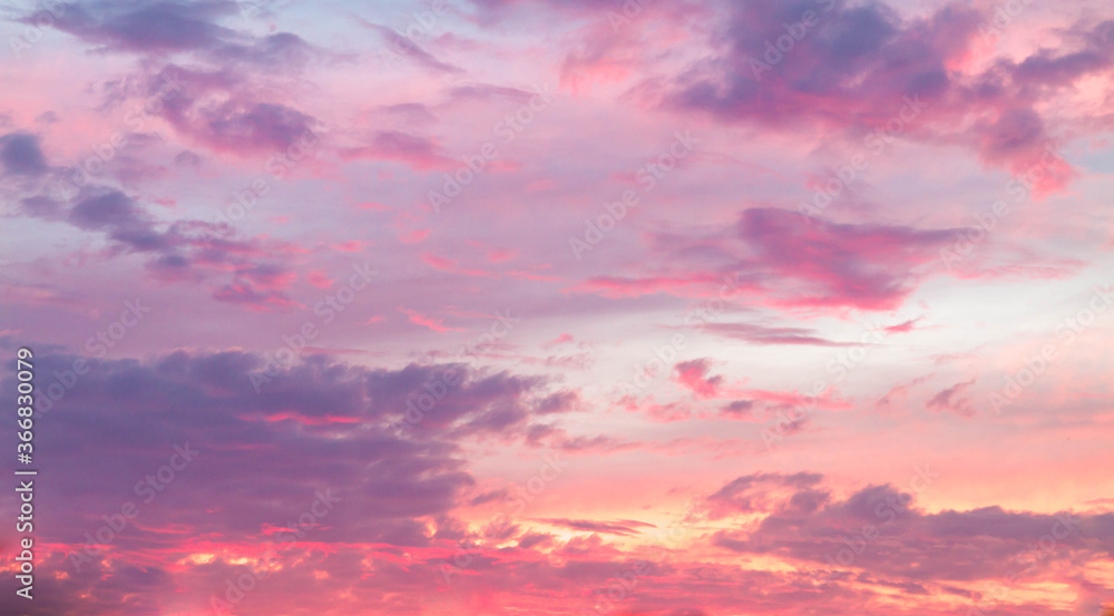 Beautiful sky at sunset in the evening. Rich colors, clouds. Pink and purple shades.