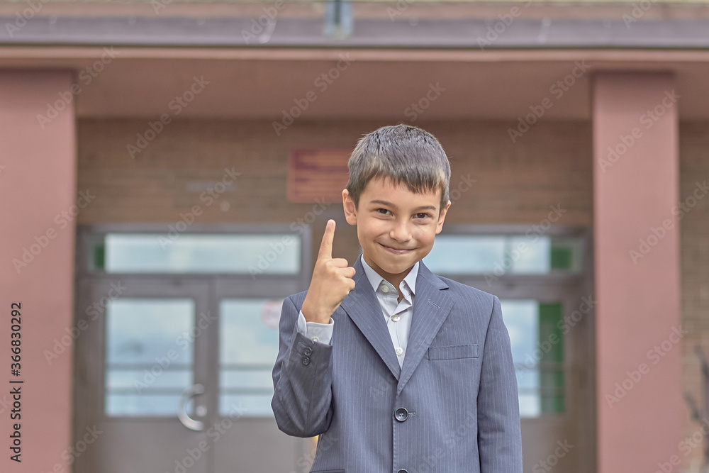 boy shows one finger back to school September 1 1st grade. boy shows one finger back to school September 1 1st grade.