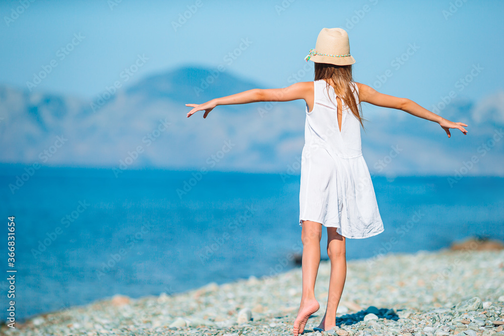 Cute little girl at beach during summer vacation Cute little girl at beach during summer vacation