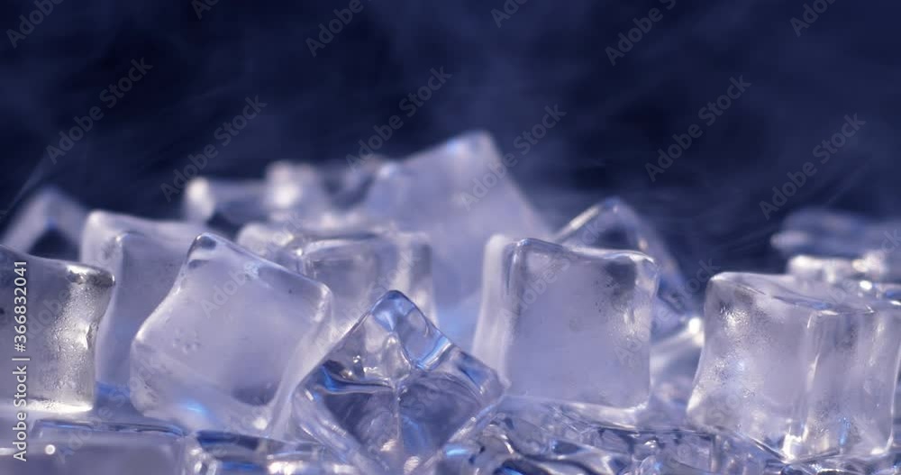Macro shot of water ice cubes slowly melting and surrounded by vapor. 4k DCI footage Macro shot of water ice cubes slowly melting and surrounded by vapor. 4k DCI footage