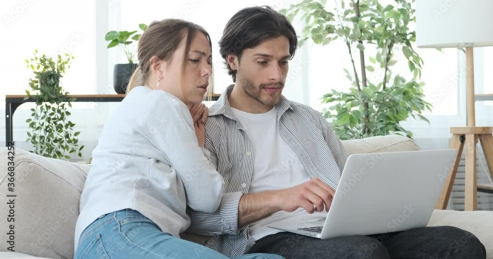 Couple spending time together using laptop at home Couple spending time together using laptop at home