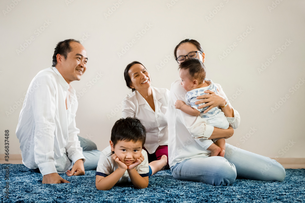 New sibling asian baby brother gets all the attention, jealous older sibling foreground with parents playing with new born younger child. asian family relationship or favorite child concept New sibling asian baby brother gets all the attention, jealous older sibling foreground with parents playing with new born younger child. asian family relationship or favorite child concept