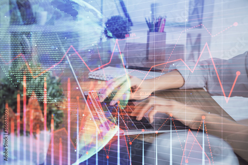 Double exposure of woman hands typing on computer and forex chart hologram drawing. Stock market invest concept.