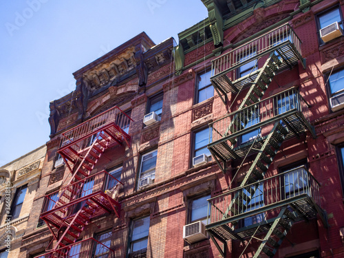 classic New York City red brick facade with fire escapes in Chinatown