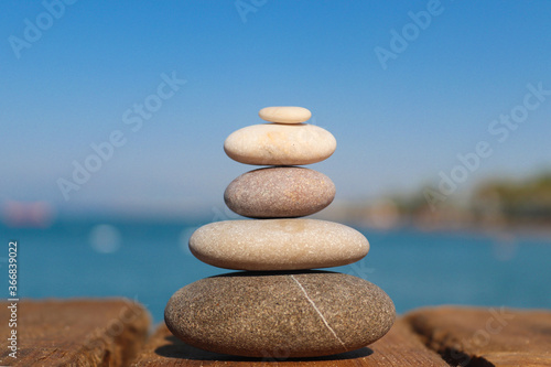 Zen concept. Stack of stones on the beach. Blurred background. Concept of harmony  stability  life balance  and meditation.