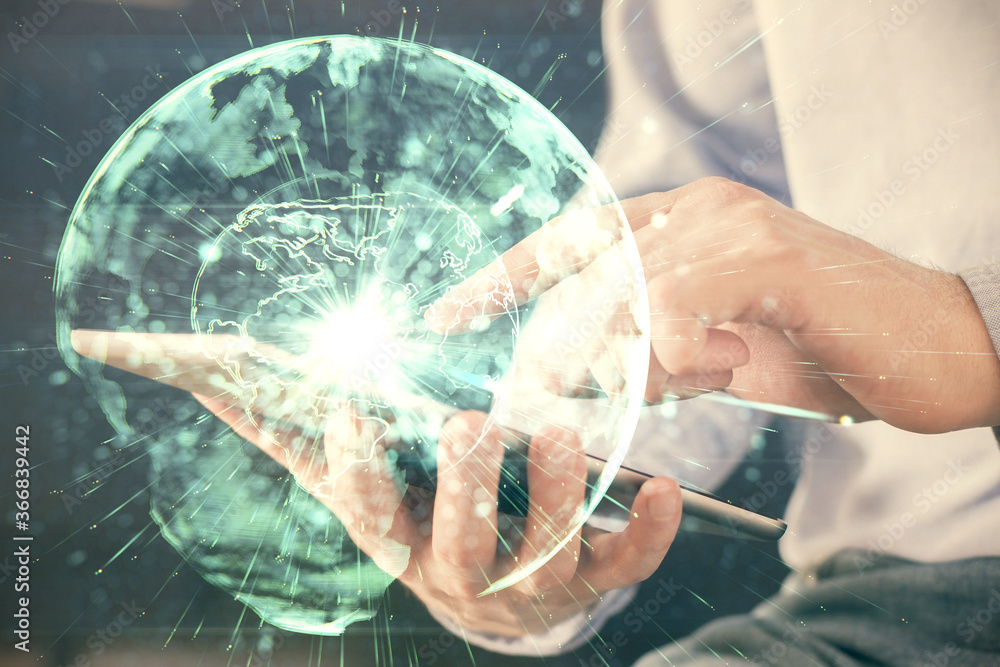 Double exposure of man's hands holding and using a phone and international business theme drawing. Double exposure of man's hands holding and using a phone and international business theme drawing.
